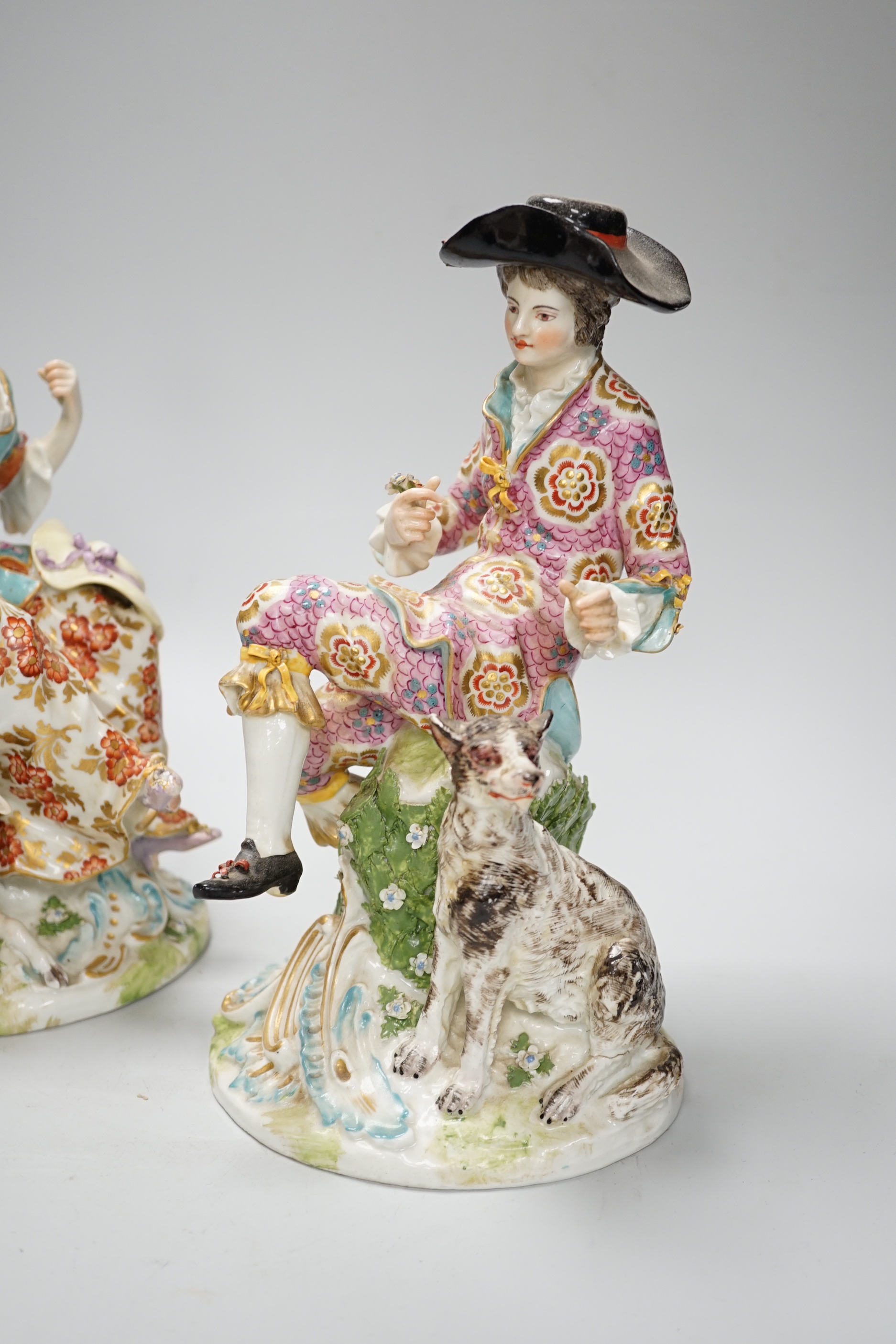 A pair of Chelsea Derby figures, seated male and female, 27.5cm